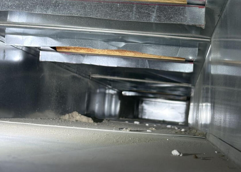 Dust and debris inside air duct before cleaning in Hillsboro, Missouri